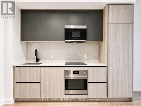 A modern kitchen with wooden cabinets and stainless steel appliances.
