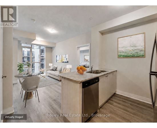 A kitchen with a dining table and chairs in a staged apartment.