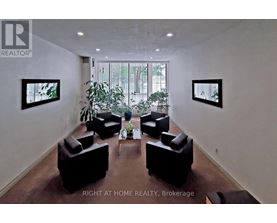 A living room with a couch, chairs, and a coffee table.