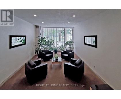 A living room with a couch, chairs, and a coffee table.