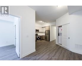 A spacious room with a doorway leading to another room.
