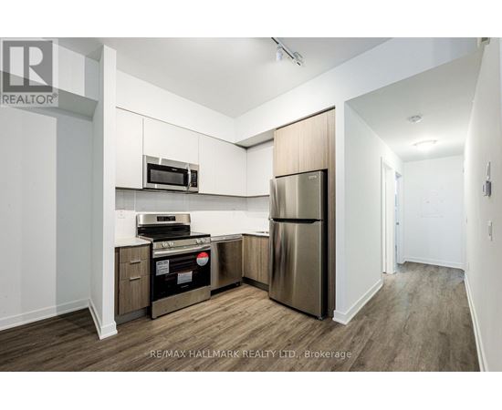 A kitchen with a stainless steel refrigerator and microwave.
