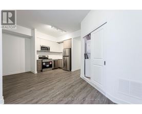 A kitchen area with a refrigerator, microwave, and oven.