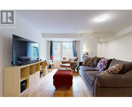 A living room with a flat screen TV on a wooden stand.