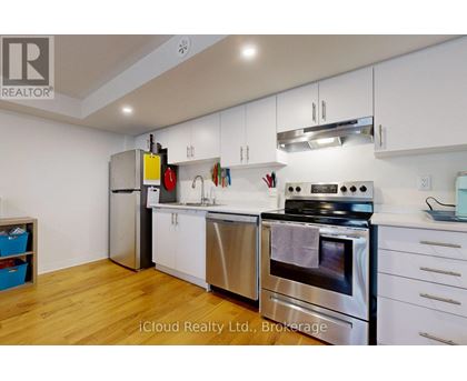 A kitchen with white cabinets and stainless steel appliances.