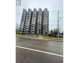 A tall residential building with a sign that reads "REALTOR" on the top left corner.