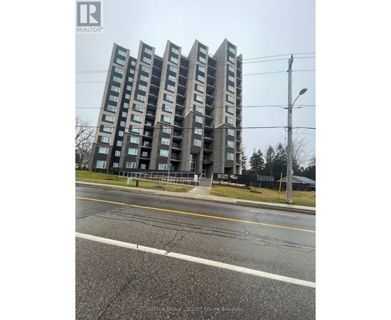 A tall residential building with a sign that reads "REALTOR" on the top left corner.