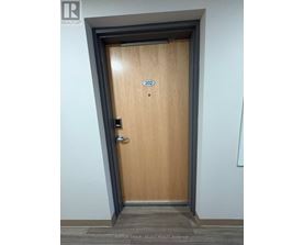 A wooden door with the number 202 on it.