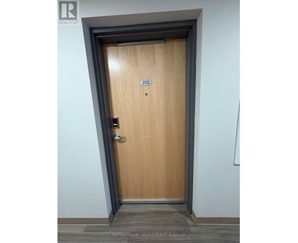 A wooden door with the number 202 on it.