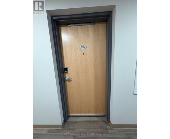 A wooden door with the number 202 on it.