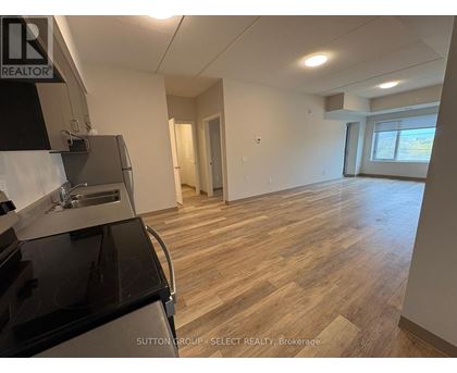 A kitchen area with a stove top oven and a sink.