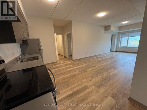 A kitchen area with a stove top oven and a sink.