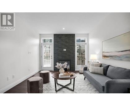 A modern living room with a grey couch and a coffee table.