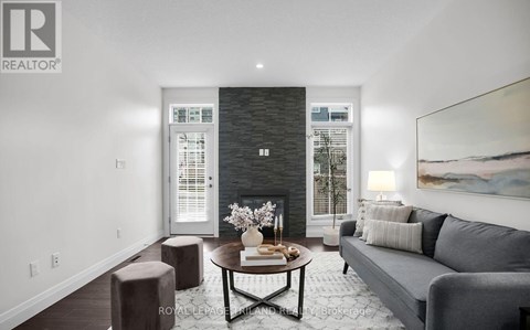 A modern living room with a grey couch and a coffee table.