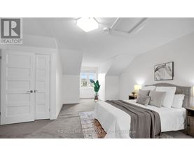 A bedroom with a large bed and a white door.