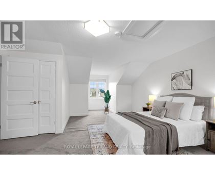 A bedroom with a large bed and a white door.