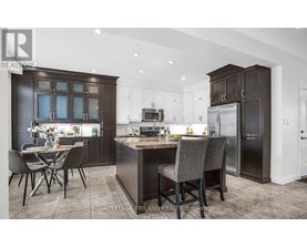 A modern kitchen with dark brown cabinets and a central island.