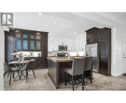 A modern kitchen with dark brown cabinets and a central island.