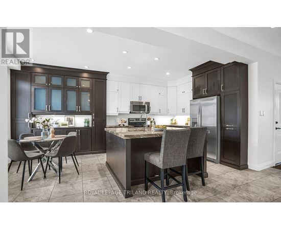 A modern kitchen with dark brown cabinets and a central island.