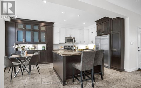 A modern kitchen with dark brown cabinets and a central island.