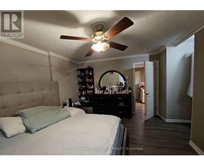 A bedroom with a bed, dresser, and mirror.
