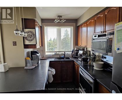 A kitchen with a large island and a microwave on top.