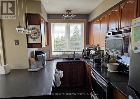 A kitchen with a large island and a microwave on top.