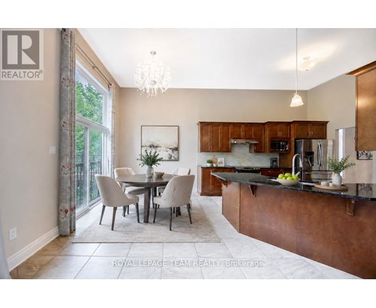 A well-lit kitchen with a dining table and chairs.