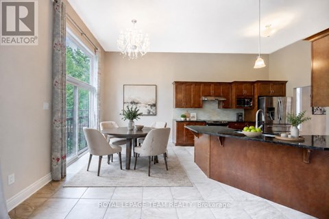 A well-lit kitchen with a dining table and chairs.