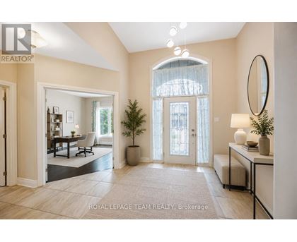 A well-lit, spacious room with a dining area and a large window.