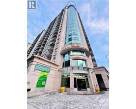 A tall building with a Cannabis store on the ground floor.