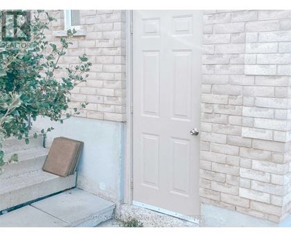 A white door is on the right side of a white brick wall.