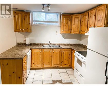 A kitchen with wooden cabinets and a granite countertop.