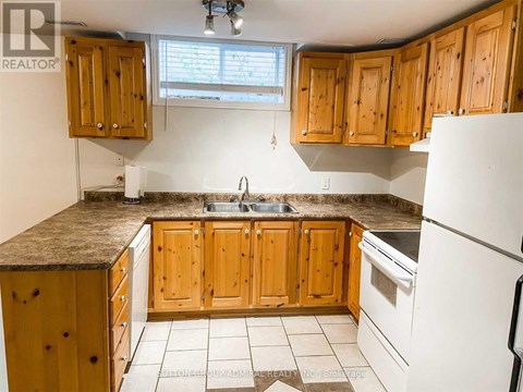 A kitchen with wooden cabinets and a granite countertop.