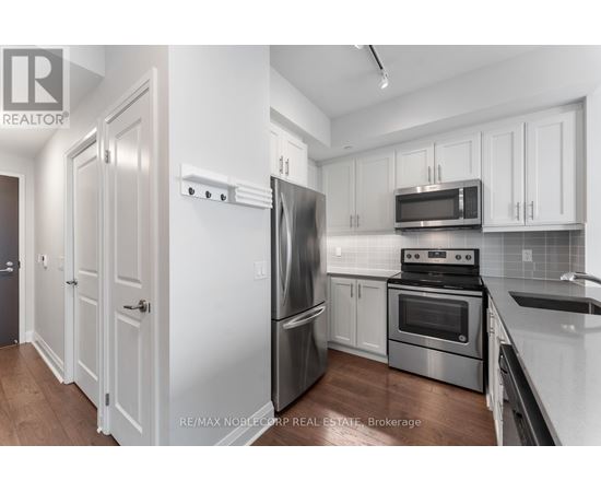A kitchen with white cabinets and stainless steel appliances.