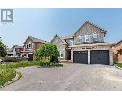 A large house with a driveway in front of it.
