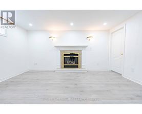 A white room with a fireplace and a door on the right.