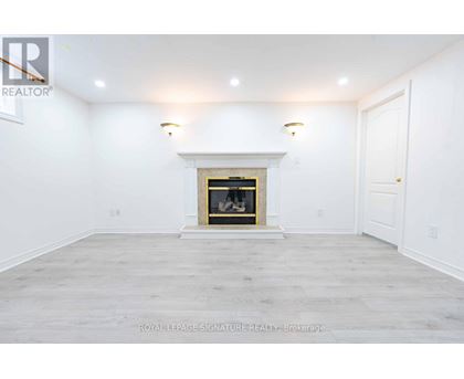 A white room with a fireplace and a door on the right.