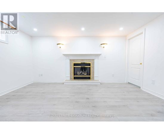 A white room with a fireplace and a door on the right.