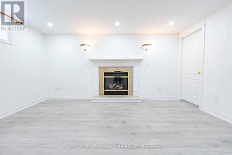 A white room with a fireplace and a door on the right.