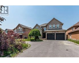 A large house with a driveway in front of it.