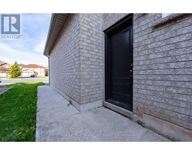 A house with a black door and a sign that says Royal LePage Signature Realty, Brokerage.