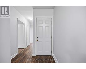 A white door is in the middle of a hallway.