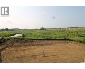 A construction site with a dirt field and a pole in the middle.