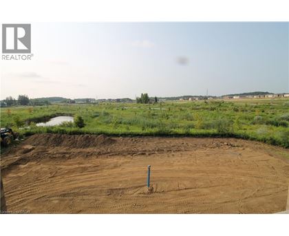 A construction site with a dirt field and a pole in the middle.