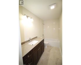 A bathroom with a sink, toilet and bathtub.