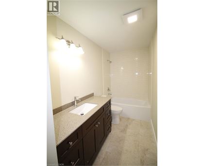A bathroom with a sink, toilet and bathtub.