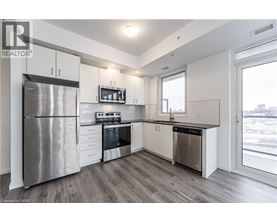 A modern kitchen with stainless steel appliances and white cabinets.