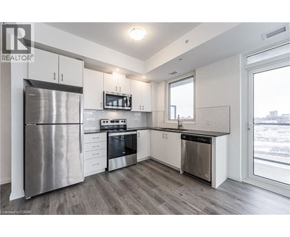 A modern kitchen with stainless steel appliances and white cabinets.