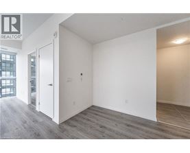 A room with a white door and a window with a view of a building outside.